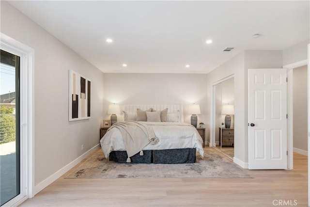 bedroom with light wood-type flooring and access to exterior