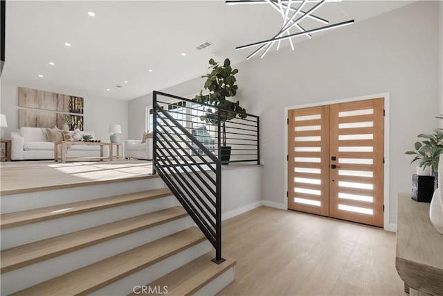 foyer entrance with light hardwood / wood-style flooring and french doors