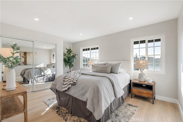 bedroom featuring light hardwood / wood-style flooring and a closet