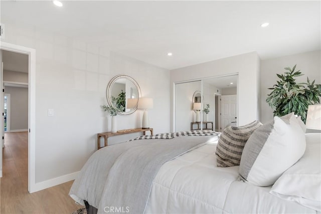 bedroom featuring light wood-type flooring and a closet