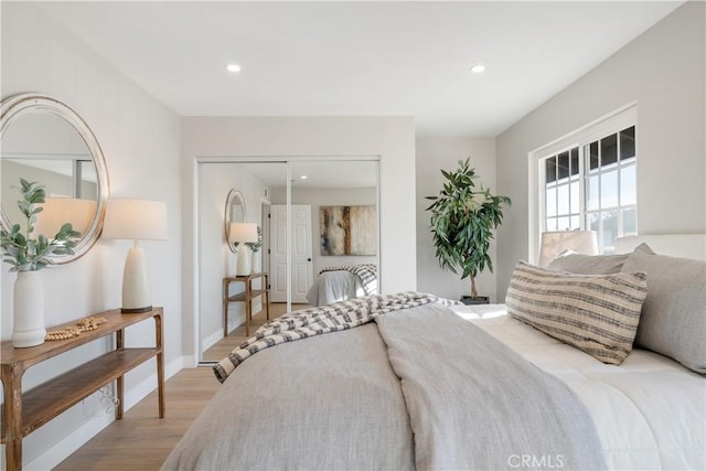 bedroom featuring light wood-type flooring and a closet