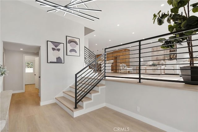 staircase with hardwood / wood-style floors