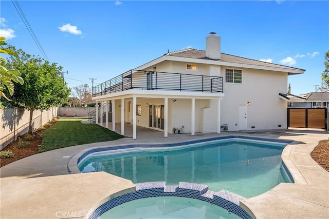 back of house with a balcony and a patio