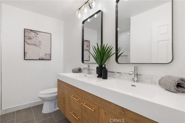 bathroom featuring toilet, tile patterned floors, and vanity