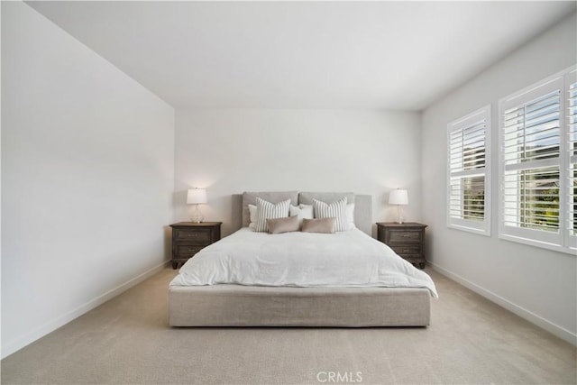 bedroom featuring light colored carpet