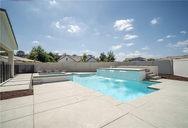 view of swimming pool featuring pool water feature, an in ground hot tub, and a patio