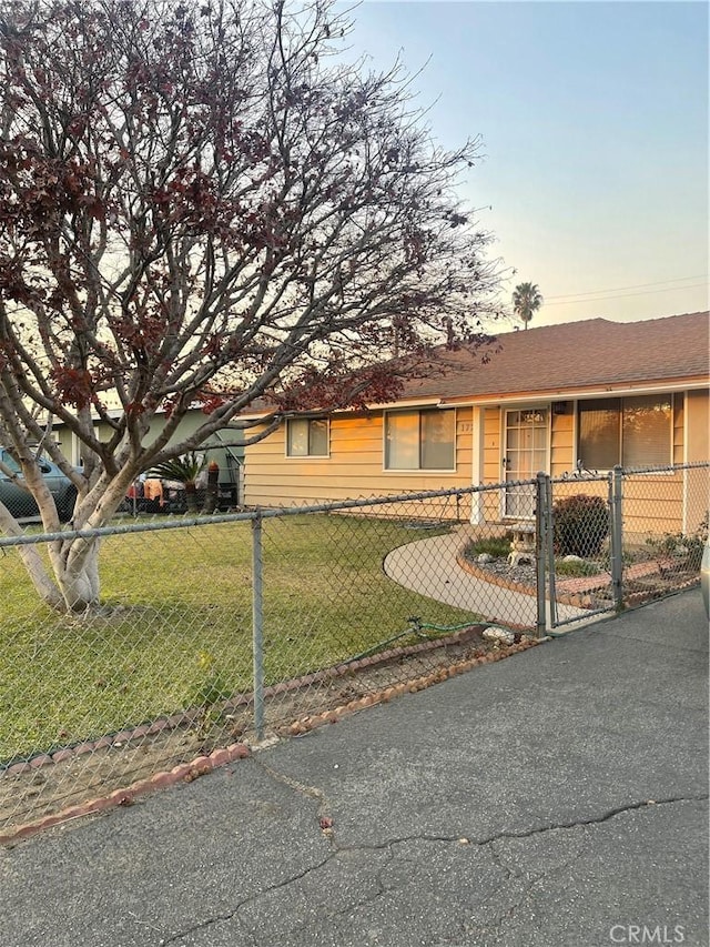 ranch-style home with a lawn