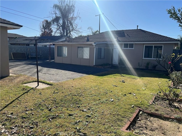 back of property with a patio and a lawn