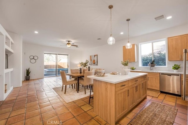 kitchen with sink, ceiling fan, dishwasher, a center island, and decorative light fixtures