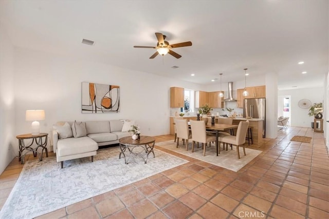 tiled living room with ceiling fan