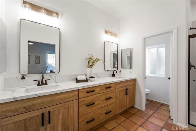 bathroom with vanity, tile patterned floors, and toilet