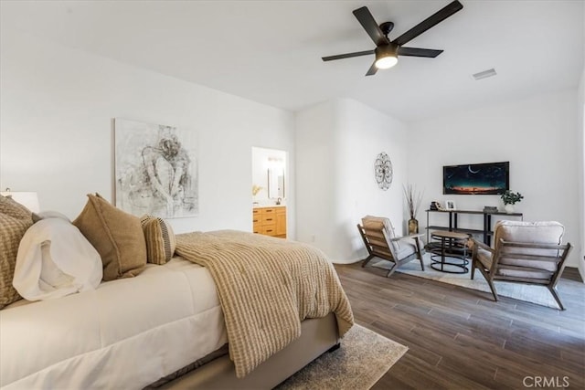 bedroom with ensuite bathroom, ceiling fan, and dark hardwood / wood-style flooring