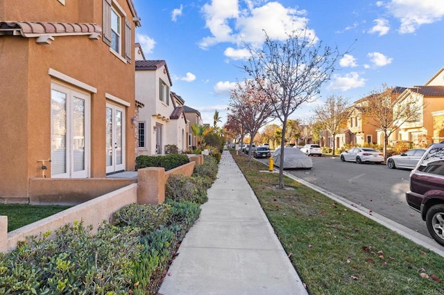 view of road featuring a residential view, curbs, and sidewalks