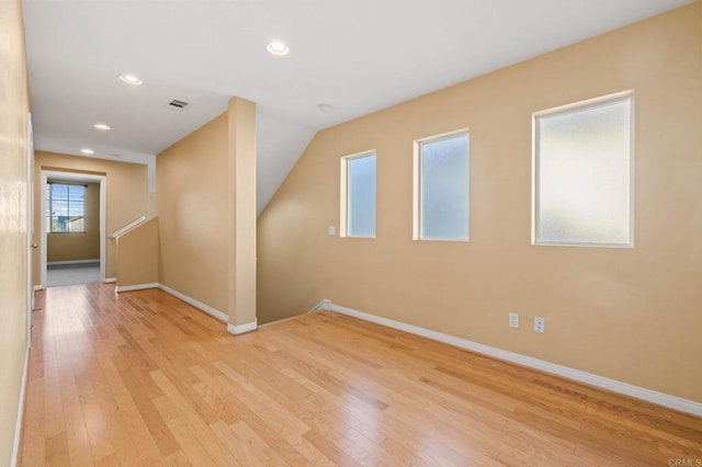 unfurnished room featuring light wood finished floors, recessed lighting, visible vents, and baseboards