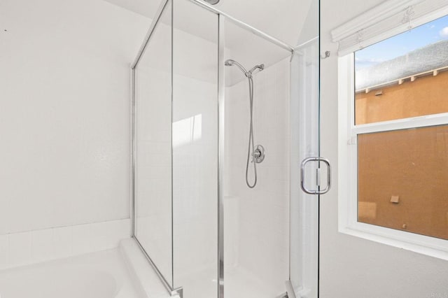 full bathroom featuring a shower stall and a bath