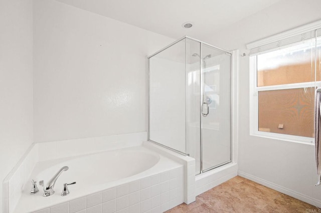 bathroom with a stall shower and a garden tub