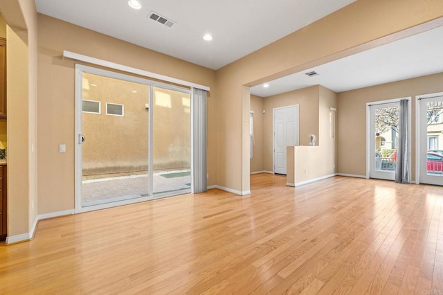 unfurnished living room featuring light wood-style flooring, recessed lighting, visible vents, and baseboards