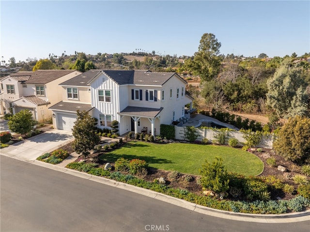 view of front of home with a front lawn and a garage