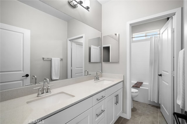 full bathroom featuring toilet, vanity, tile patterned flooring, and shower / tub combo