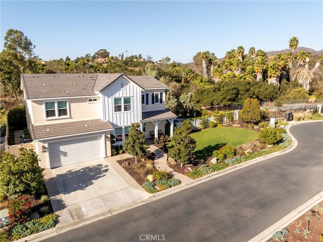 view of front of home featuring a garage and a front yard