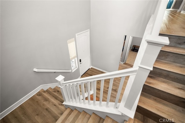 stairs featuring hardwood / wood-style floors