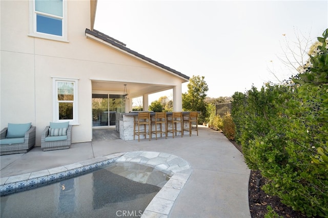 view of patio with an outdoor bar