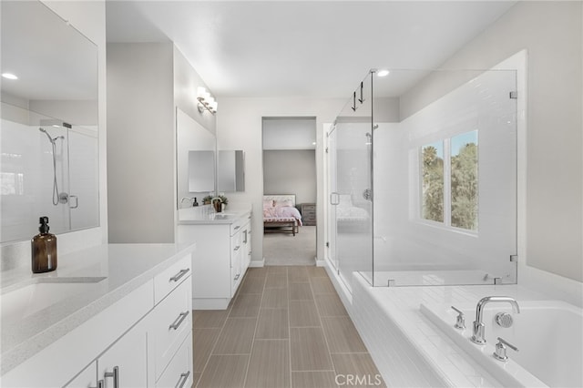 bathroom featuring vanity and independent shower and bath