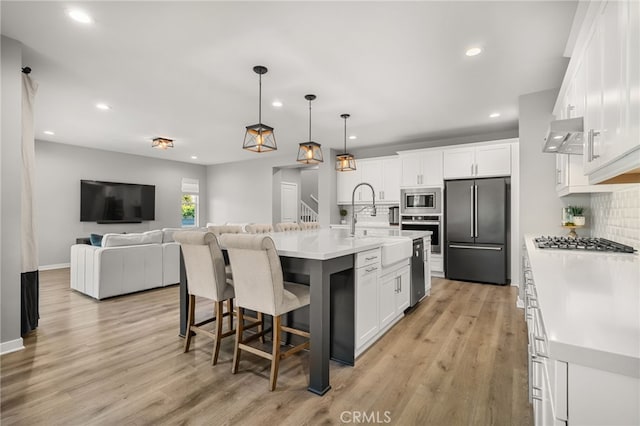 kitchen with decorative backsplash, stainless steel appliances, and white cabinetry