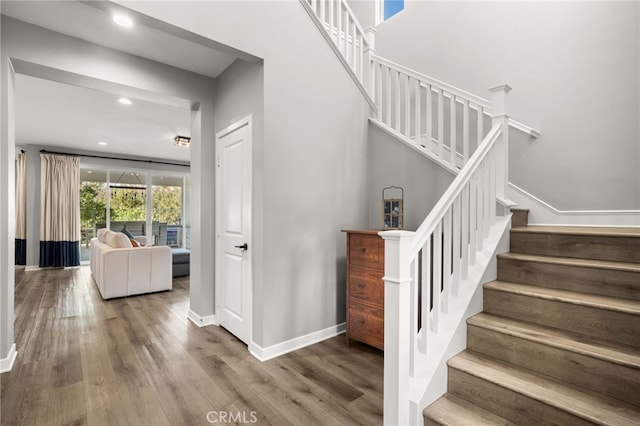 stairs with hardwood / wood-style floors