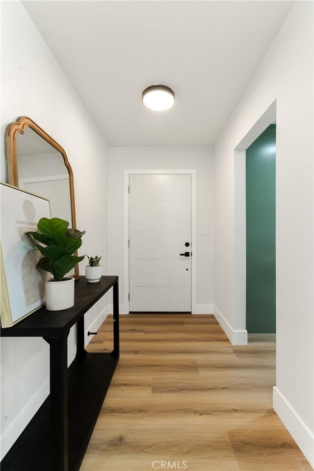 doorway with wood-type flooring