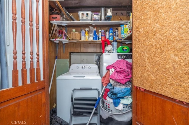 washroom with washer / dryer and wood walls