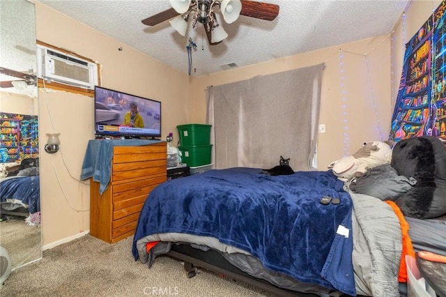 carpeted bedroom featuring ceiling fan, a wall mounted AC, and a textured ceiling