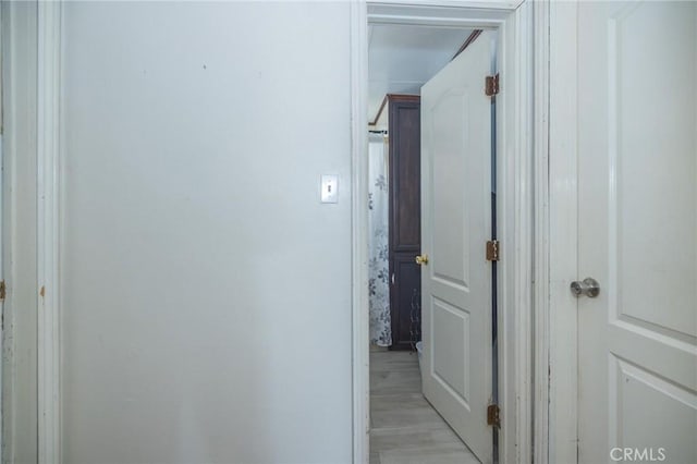 corridor with light hardwood / wood-style flooring