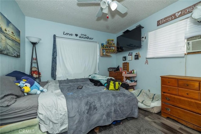 bedroom featuring ceiling fan, a textured ceiling, and hardwood / wood-style flooring