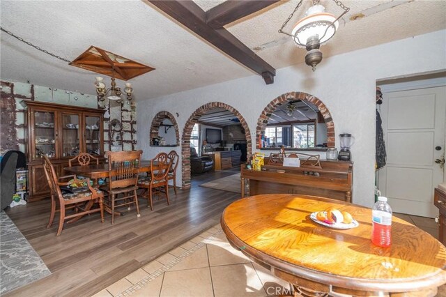 dining space with ceiling fan, a textured ceiling, and hardwood / wood-style flooring