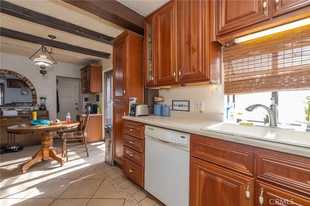 kitchen with light tile patterned floors, white dishwasher, pendant lighting, beam ceiling, and sink