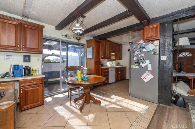 kitchen with a textured ceiling, dishwasher, beamed ceiling, stainless steel refrigerator, and ceiling fan