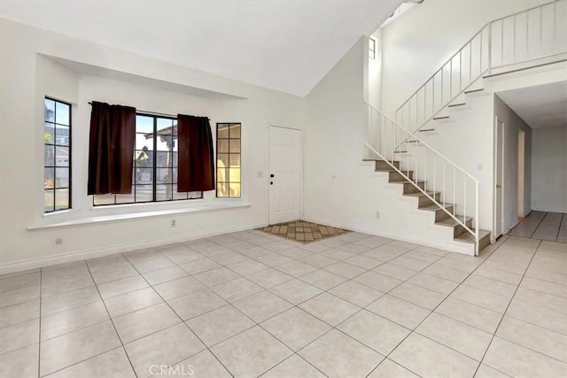 tiled entrance foyer featuring lofted ceiling