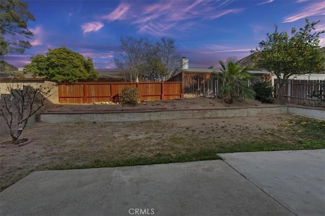 yard at dusk with a patio area