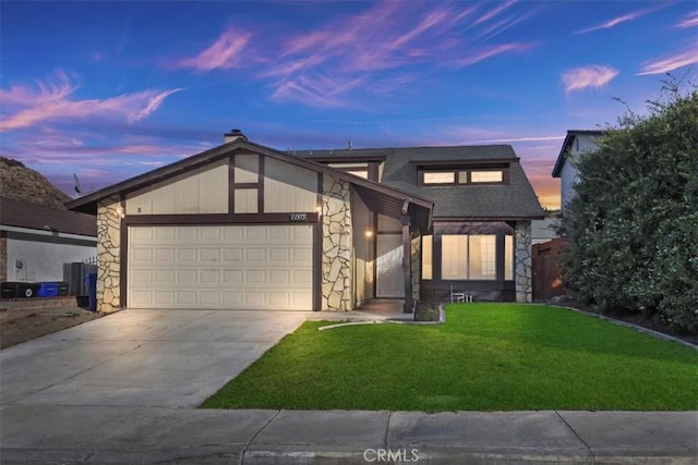 view of front of house featuring a garage and a lawn