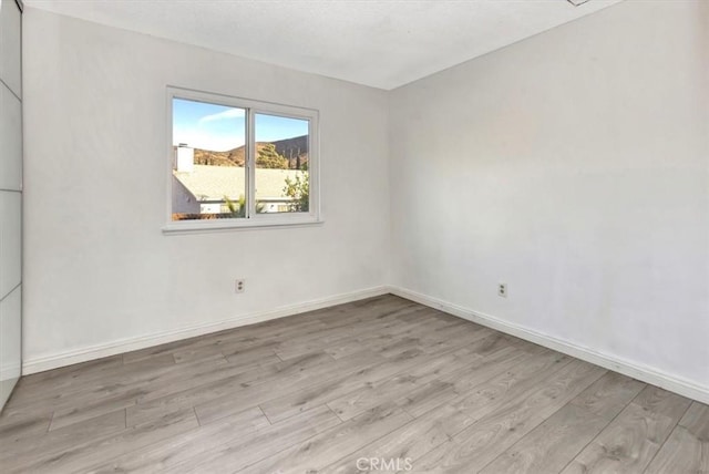 unfurnished room with light hardwood / wood-style floors