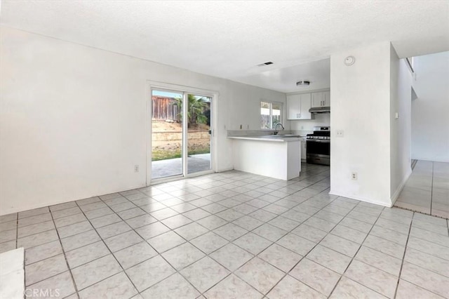 interior space featuring sink and light tile patterned floors