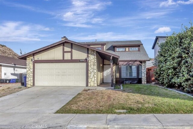 view of front of property with a front lawn and a garage