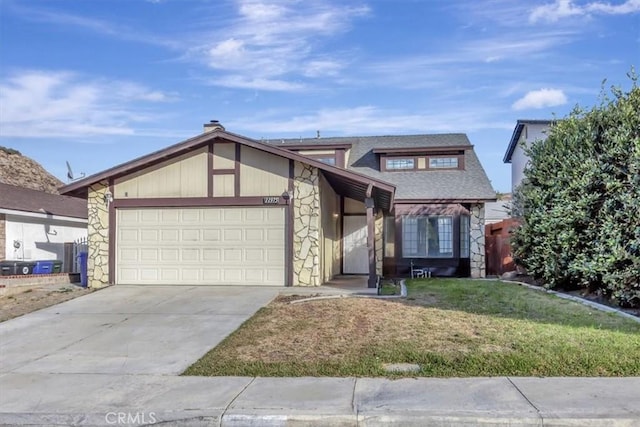 view of front of home with a front lawn and a garage