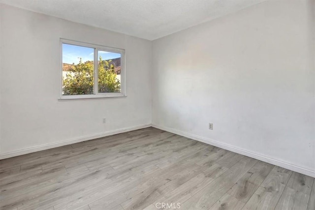 unfurnished room with light hardwood / wood-style floors