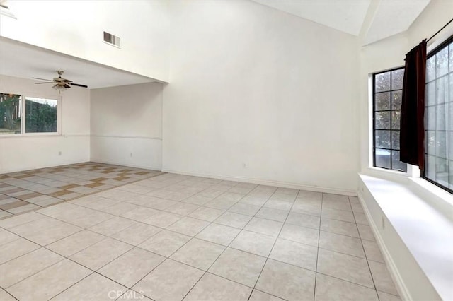 unfurnished room featuring ceiling fan and light tile patterned floors