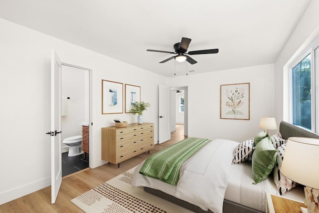 bedroom featuring ceiling fan, connected bathroom, and light hardwood / wood-style flooring