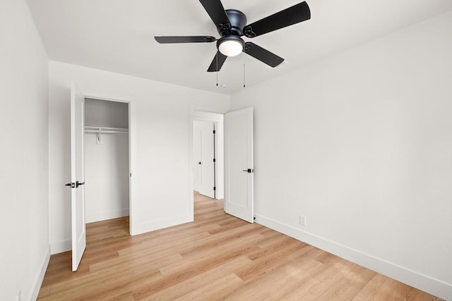 unfurnished bedroom featuring ceiling fan, light wood-type flooring, and a closet