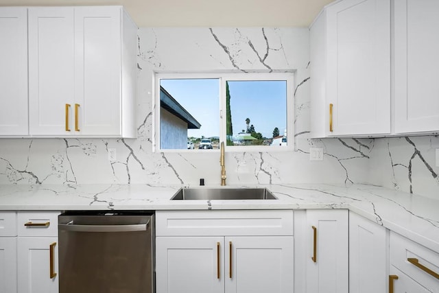 kitchen with white cabinets, backsplash, dishwasher, and sink