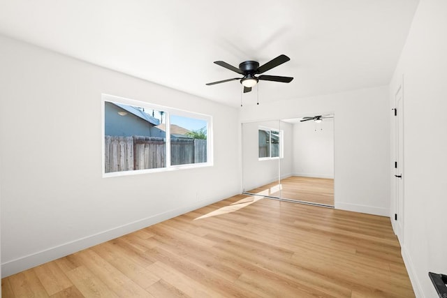 unfurnished bedroom featuring ceiling fan, a closet, and light hardwood / wood-style flooring